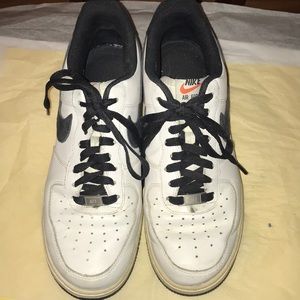 White Nike AF1s whit black accents.